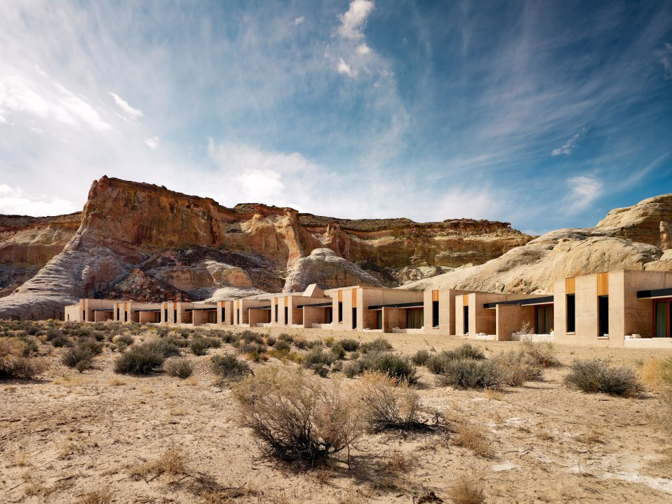 Amangiri Hotel's concrete pavilions with yellow and black accents set against Utah desert rock formations.
