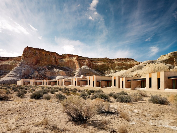 Amangiri Hotel's concrete pavilions with yellow and black accents set against Utah desert rock formations.