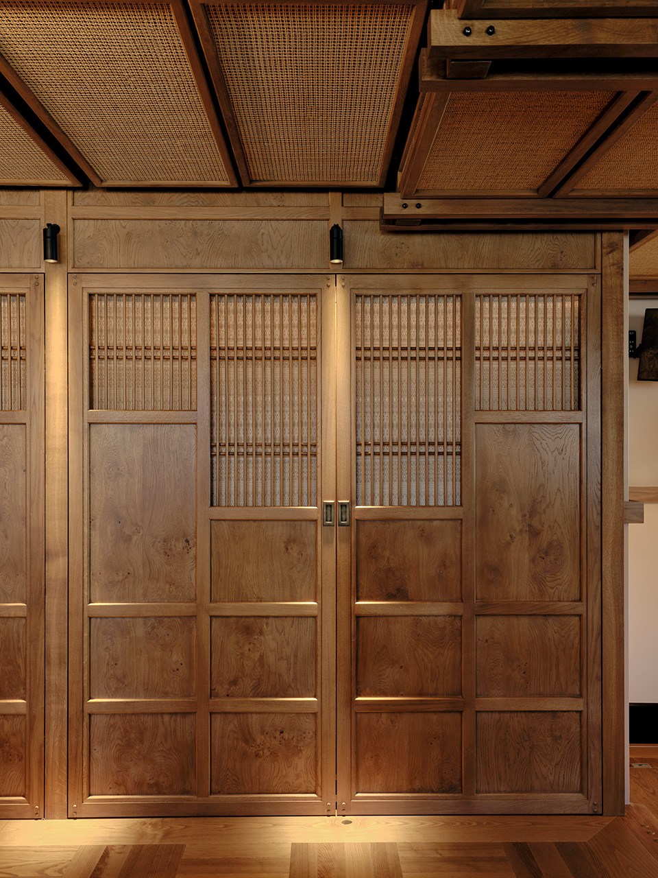 Detailed view of custom wood wall paneling with geometric patterns and rich grain textures
