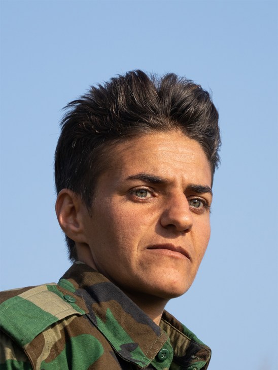 Kurdish fighter with weapon in outdoor training environment