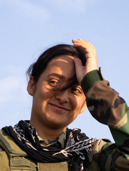 Kurdish fighter in green fatigues during a pause in training