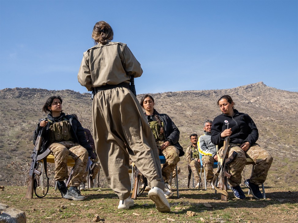 Komala Party members seated and listening to a political lecture at their training camp