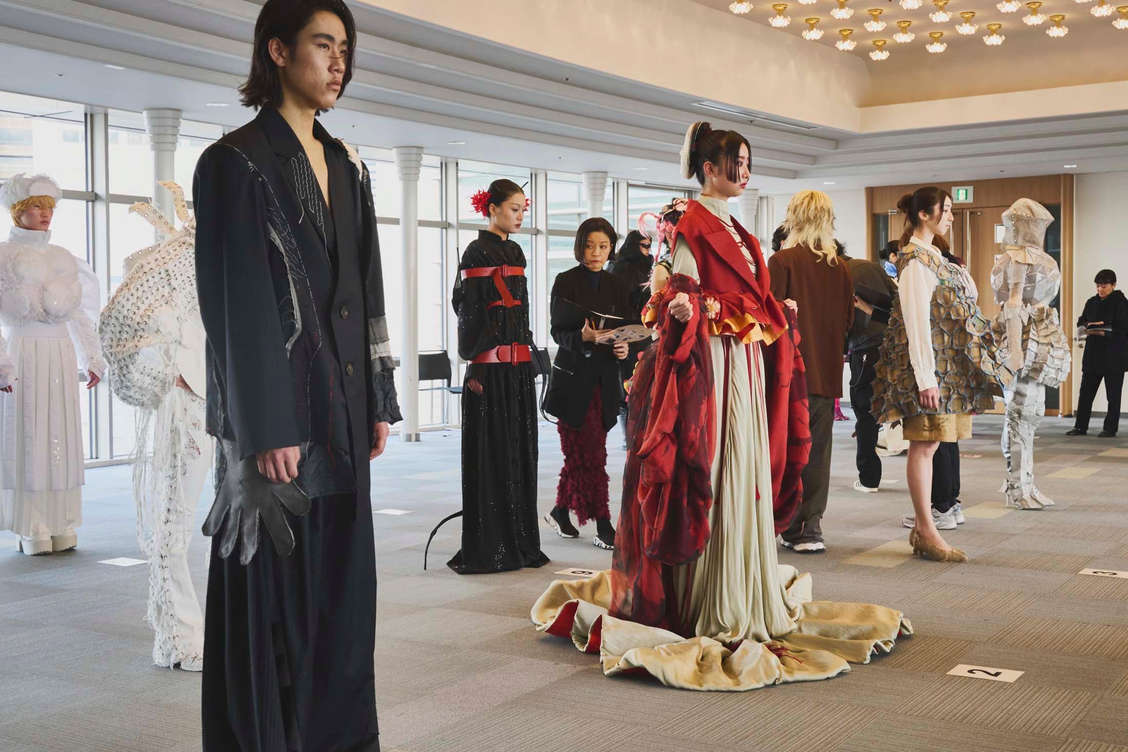 Judges look over the finalists in the design category of a competition at Bunka Fashion College, Tokyo