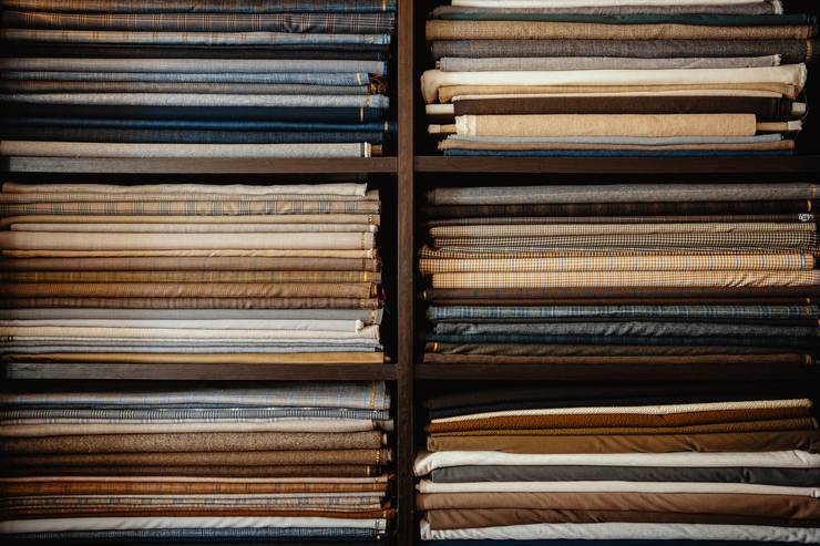 A selection of fabrics on a shelf.