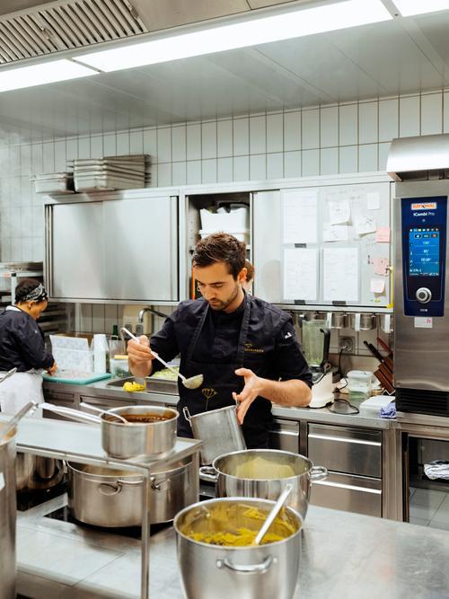 A chef preparing a sauce.