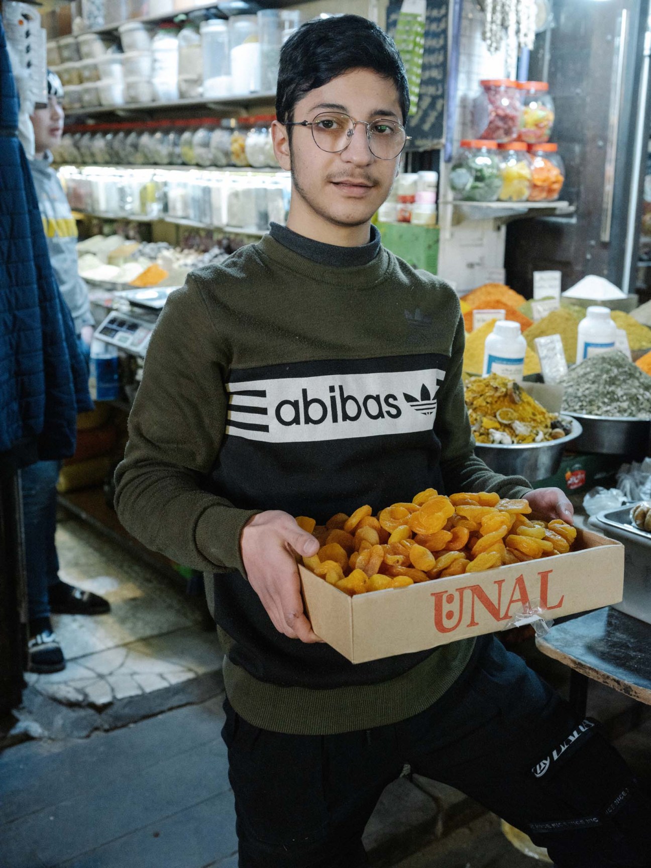 Syria, Damascus, 2025. At his store in the historic Souk al-Hamidiyeh, Abdulrahman al Horani (17) is selling Turkish dried apricots and cevizli sucuk, a walnut-filled confectionary from Anatolia, Turkey.