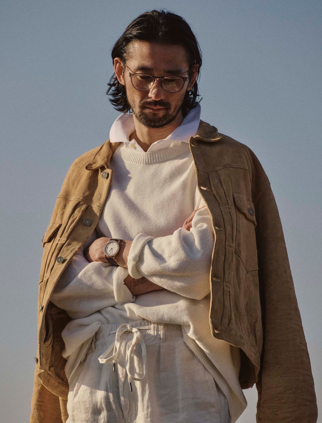 Jacket by Visvim, jumper by Comoli, polo shirt and trousers by Polo Ralph Lauren, bvlgari bvlgari watch by Bvlgari, glasses by Mykita