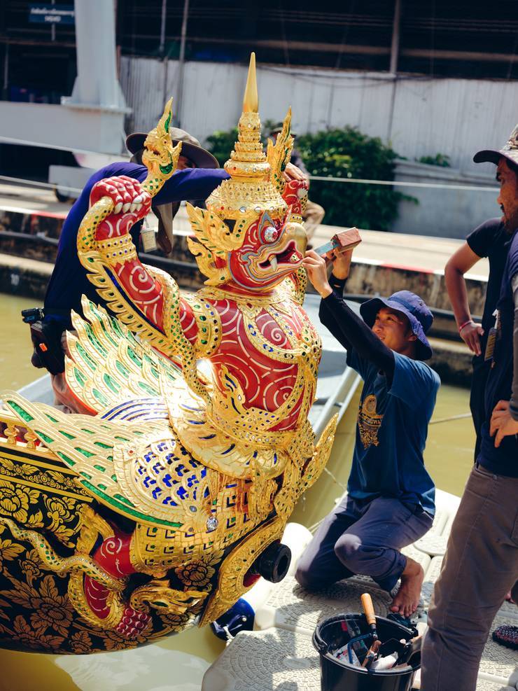 Artisans from the Thai government’s fine arts department put the finishing touches to the boats