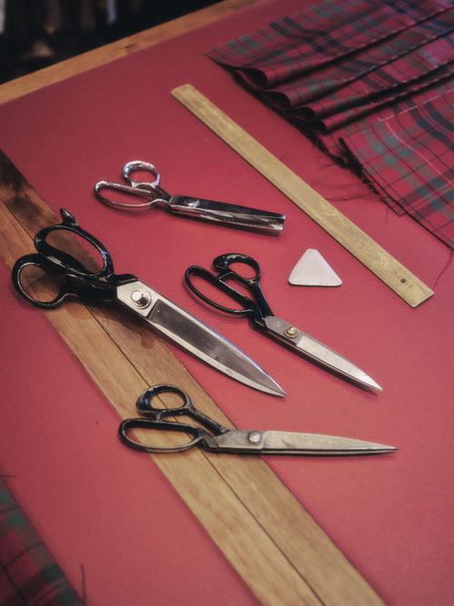 A selection of scissors and a ruler on a measuring table.