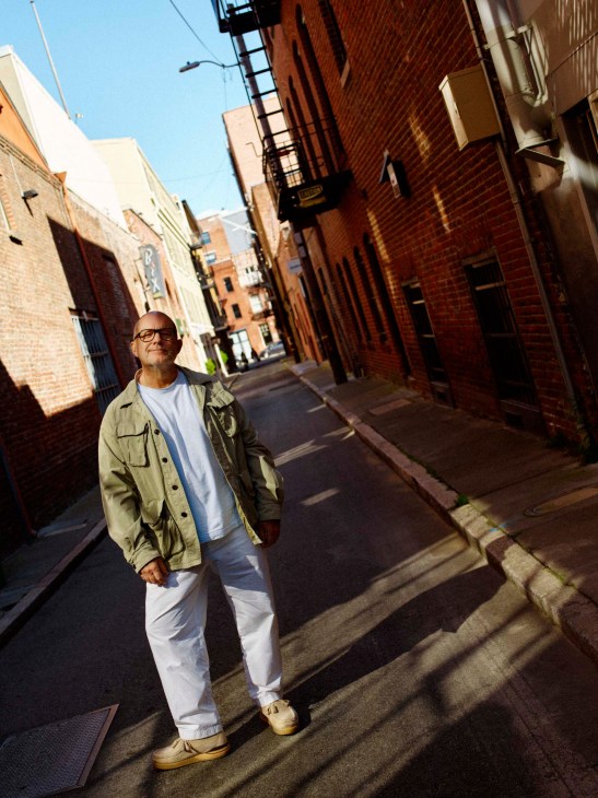 Jony Ive in a sunlight alleyway