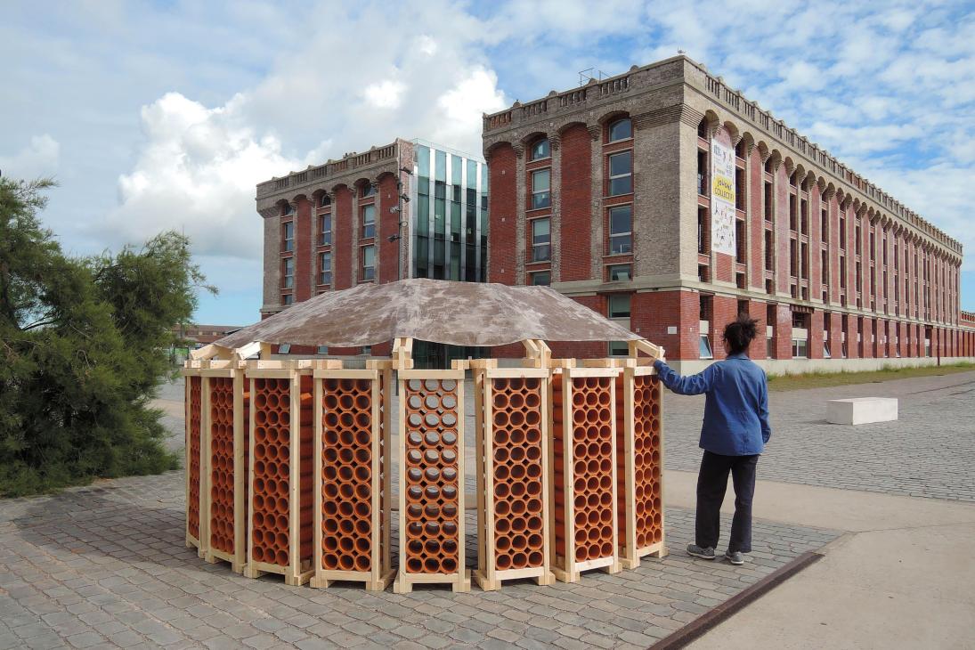 A person standing near the Pavillon de l’air 