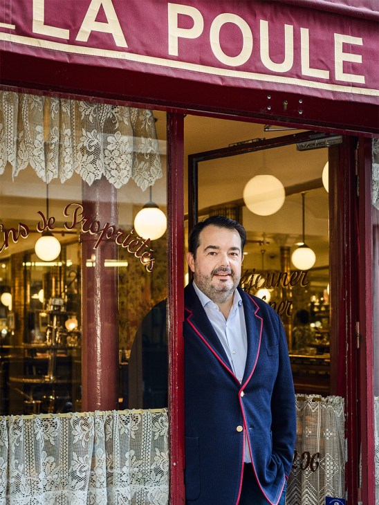 chef Jean-François Piège stands in the doorway of restaurant La Poule au Pot