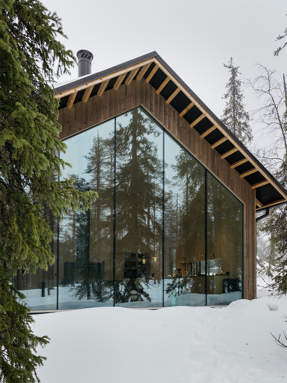 Exterior of glass-fronted villa housu in Finnish Lapland