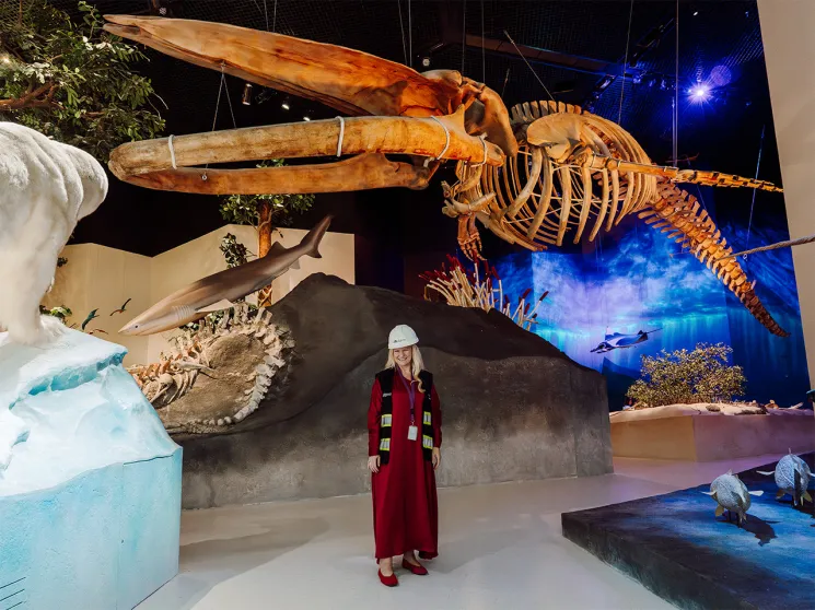 Judith McAlester stands in front of whale skeleton in the Natural History Museum Abu Dhabi
