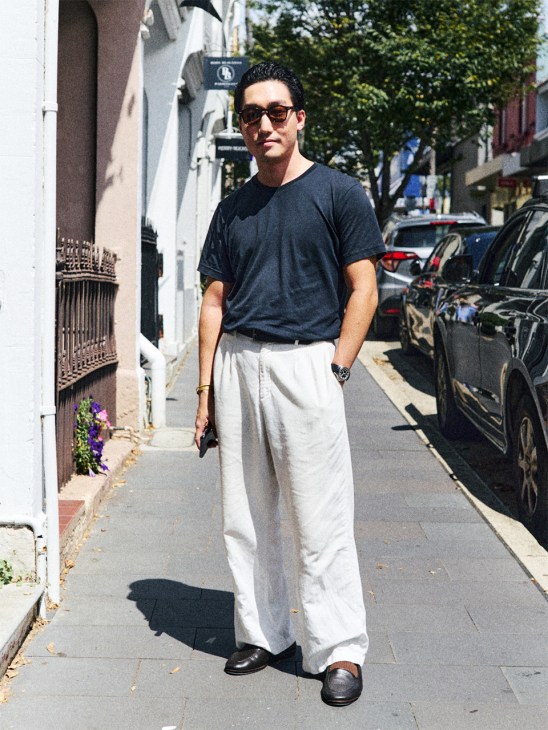 Man wearing a navy tshirt and white trousers in Paddington, Sydney