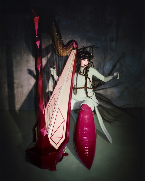 Björk performing with a large harp