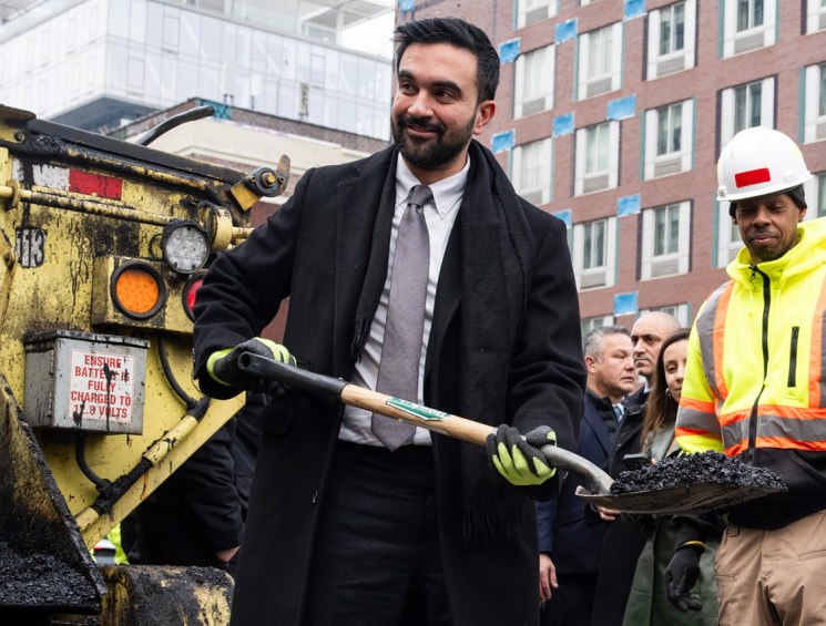 Zohran Mamdani, mayor of New York, uses a spade to fill a hole during a news conference with New York Department of Transportation (DOT) workers in New York, US, on Tuesday, Jan. 6, 2026. The New York Department of Transportation (DOT) is working to redesign the "Williamsburg Bridge bump," two inch high steel plates that cover the expansion joints on the bridge's pedestrian and bike path which have caused numerous cyclist crashes, complaints, and lawsuits. Photographer: Adam Gray/Bloomberg via Getty Images