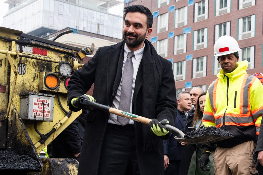 Zohran Mamdani, mayor of New York, uses a spade to fill a hole during a news conference with New York Department of Transportation (DOT) workers in New York, US, on Tuesday, Jan. 6, 2026. The New York Department of Transportation (DOT) is working to redesign the "Williamsburg Bridge bump," two inch high steel plates that cover the expansion joints on the bridge's pedestrian and bike path which have caused numerous cyclist crashes, complaints, and lawsuits. Photographer: Adam Gray/Bloomberg via Getty Images