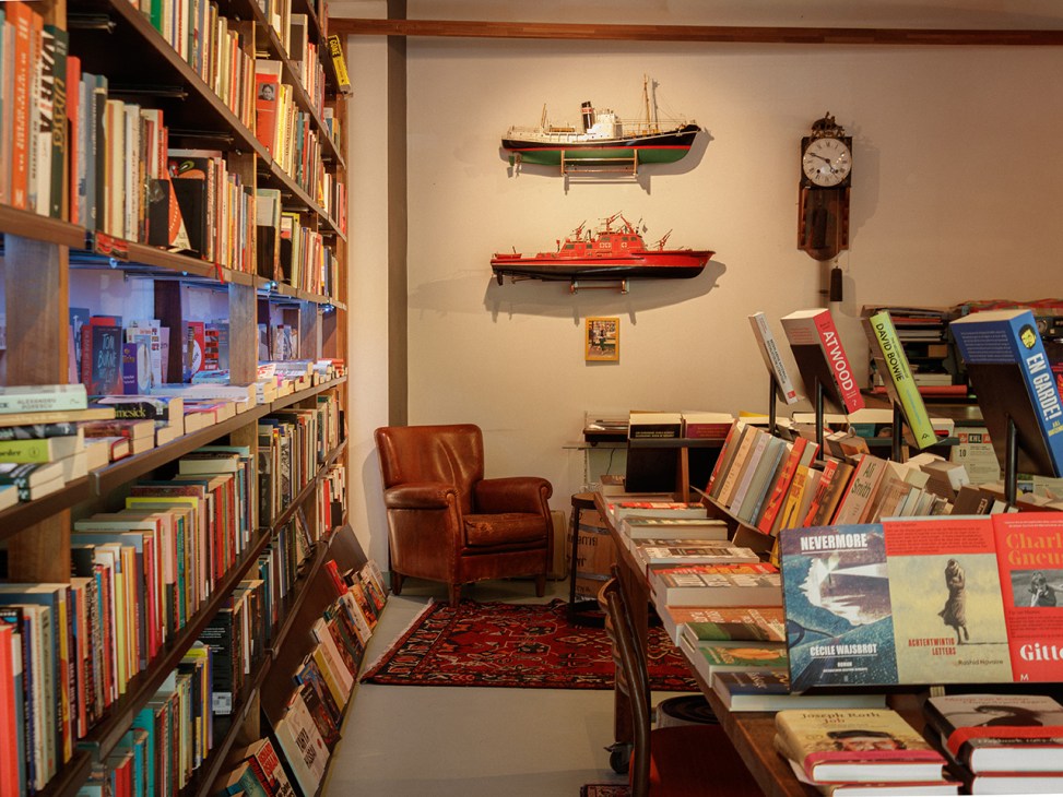 Books and an armchair inside De Boekhandel van Pampus book shop in Amsterdam