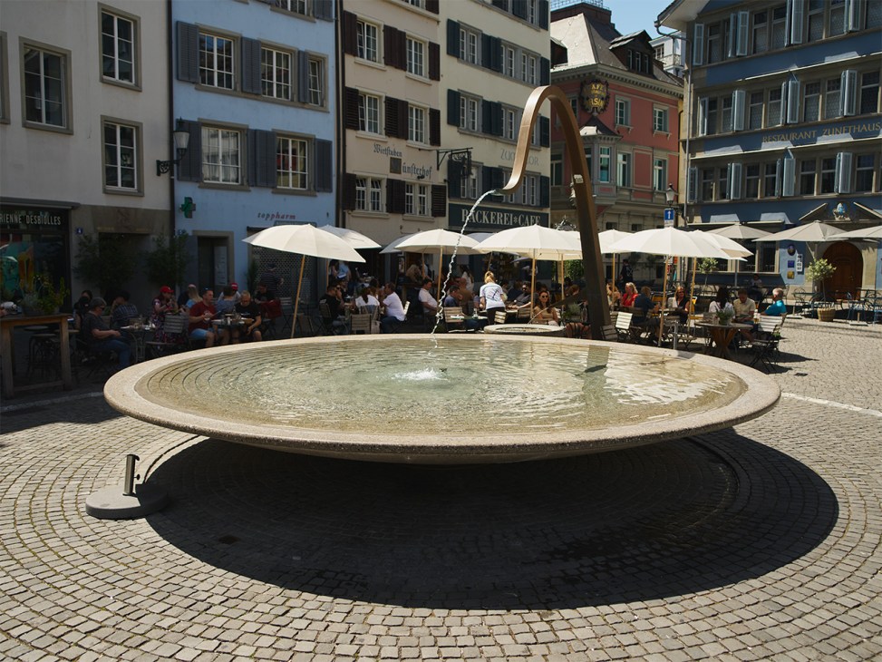 A sleek drinking fountain on Münsterhof square in Zurich completed in 2017