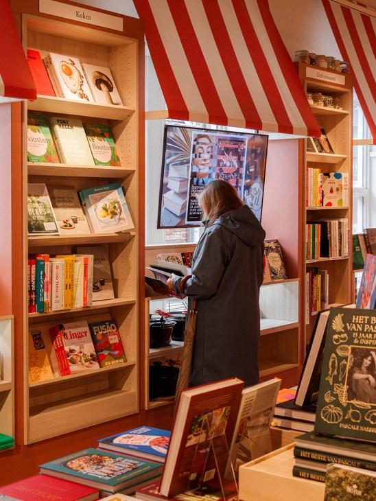 A shopper browsing Scheltema bookshop in Amsterdam