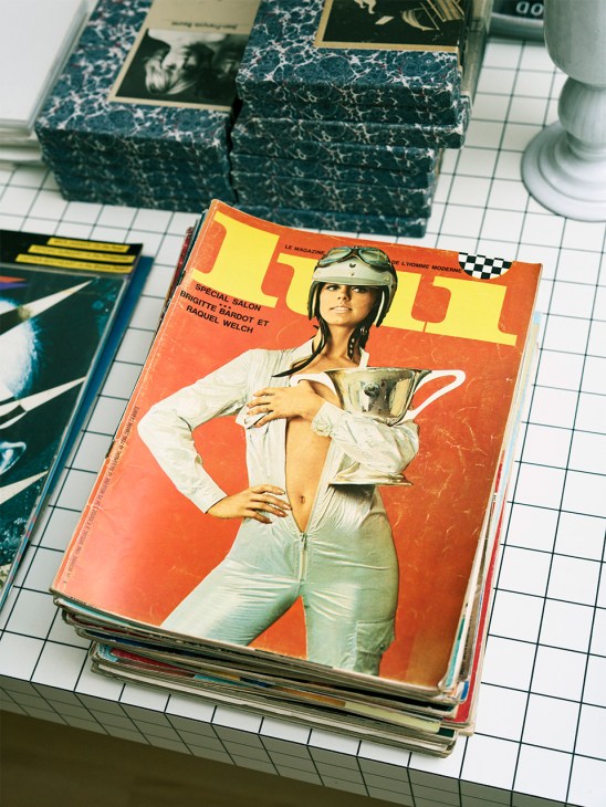 Vintage copy of Lui magazine with orange cover featuring woman in white shirt and racing helmet