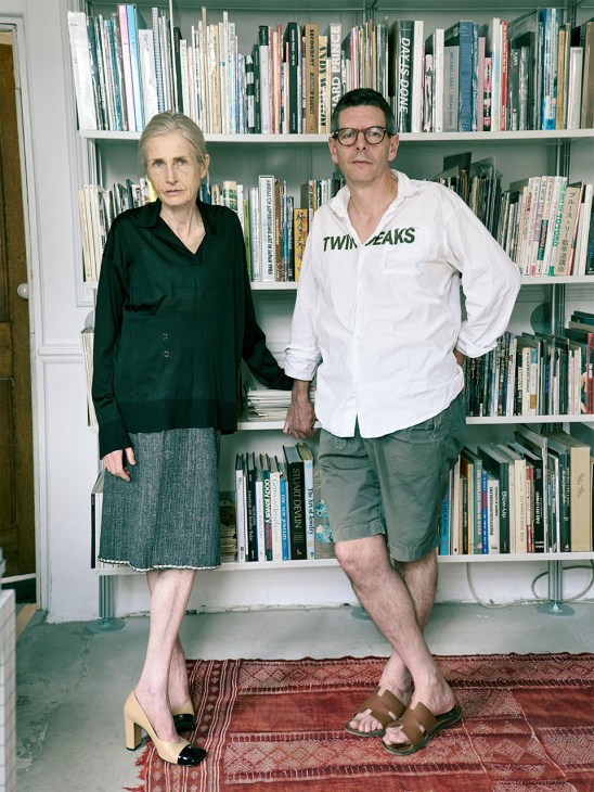 Founders Angela Hill and David Owen standing in front of bookshelves at their Idea bookshop in London's Soho.