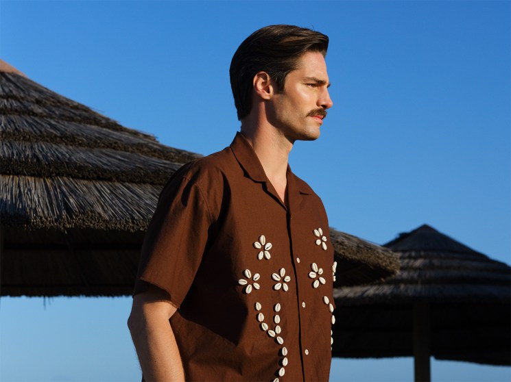 Man standing on the beach in a summer shirt