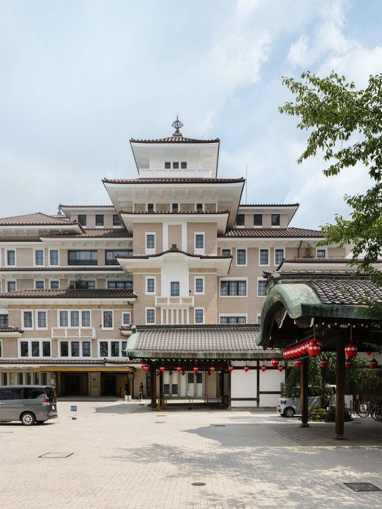 The Imperial Hotel in Kyoto's Gion district features traditional tiered roofs with curled eaves and a modern cream-colored facade.