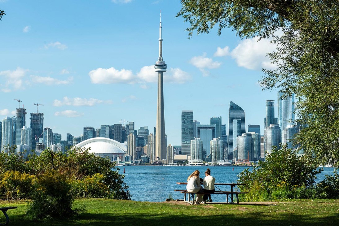 People enjoy the view of the CN (Canadian National) Tower and the Toronto skyline from the Toronto Islands on Lake Ontario, September 14, 2023. (Photo by VALERIE MACON / AFP) (Photo by VALERIE MACON/AFP via Getty Images)
