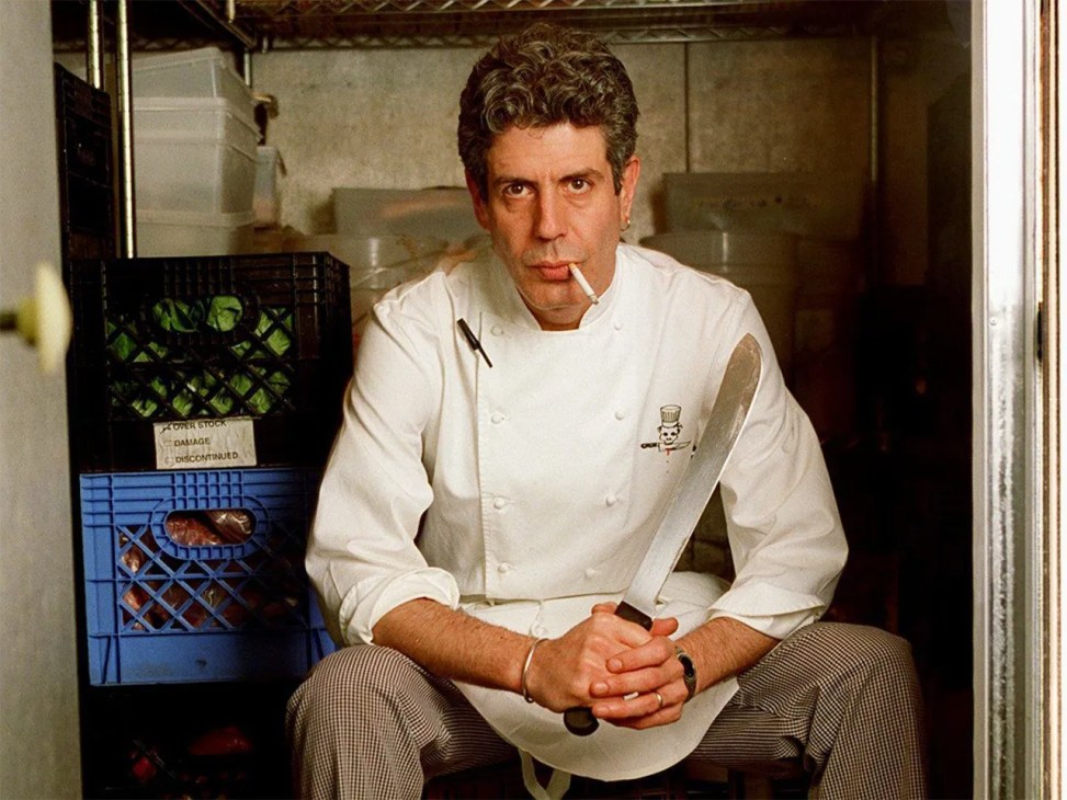 Anthony Bourdain with a knife and a cigarette