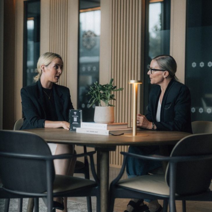 Colleagues speaking inside a meeting room at IPUT