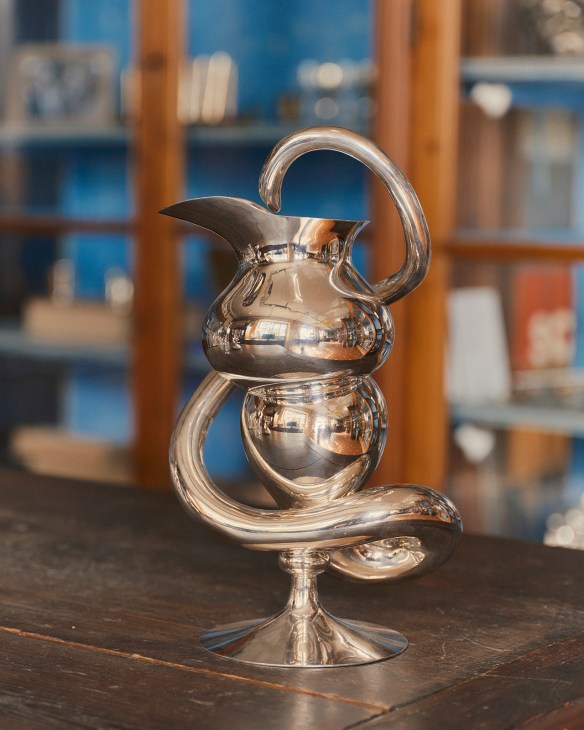 Polished silver jug with curved spout and handle made by Pampaloni workshop in Florence.