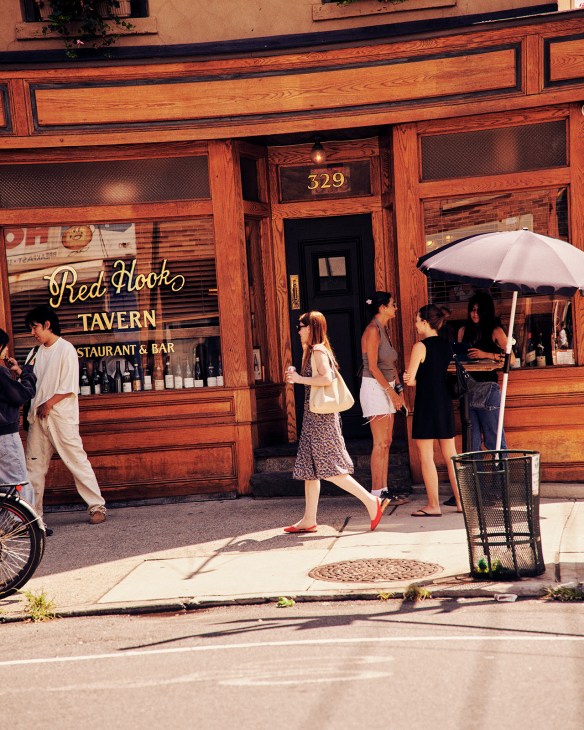 Customers outside Red Hook Tavern restaurant and bar with wooden storefront at number 329
