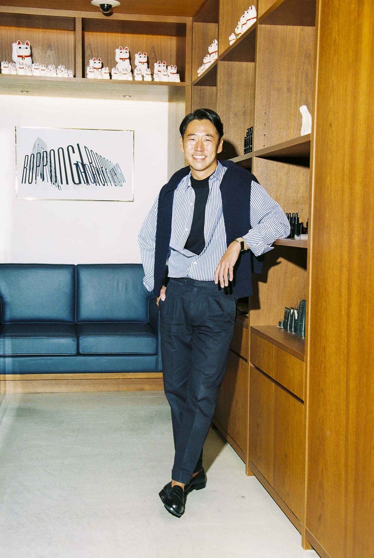 Jun Takahashi wearing a United Arrows shirt and loafers, standing in the Roppongi store