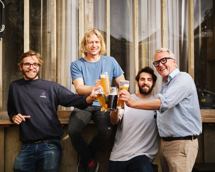 Four men toasting with beer glasses outside German Kraft brewery at Mercato Metropolitano, Florian Bollen on right