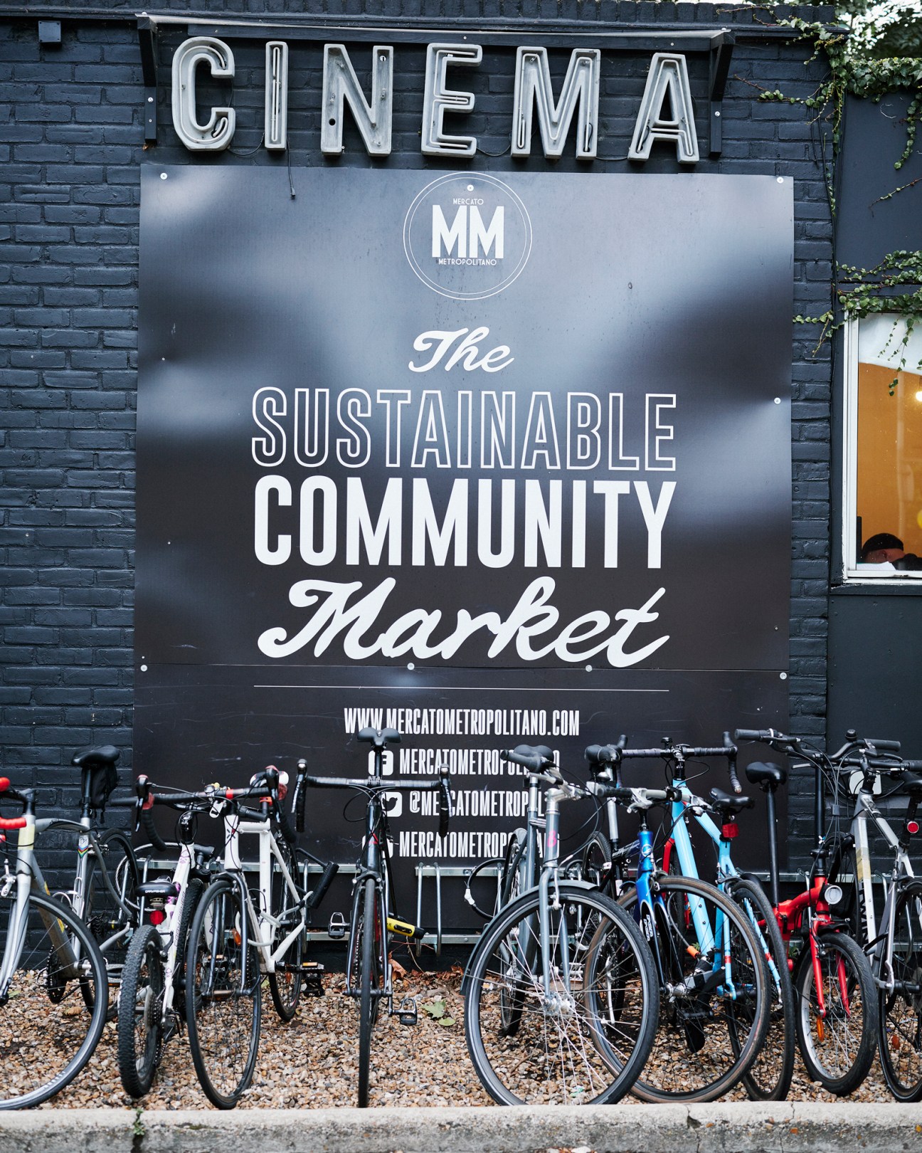 Outdoor cinema screening at Mercato Metropolitano with people seated watching a projected film
