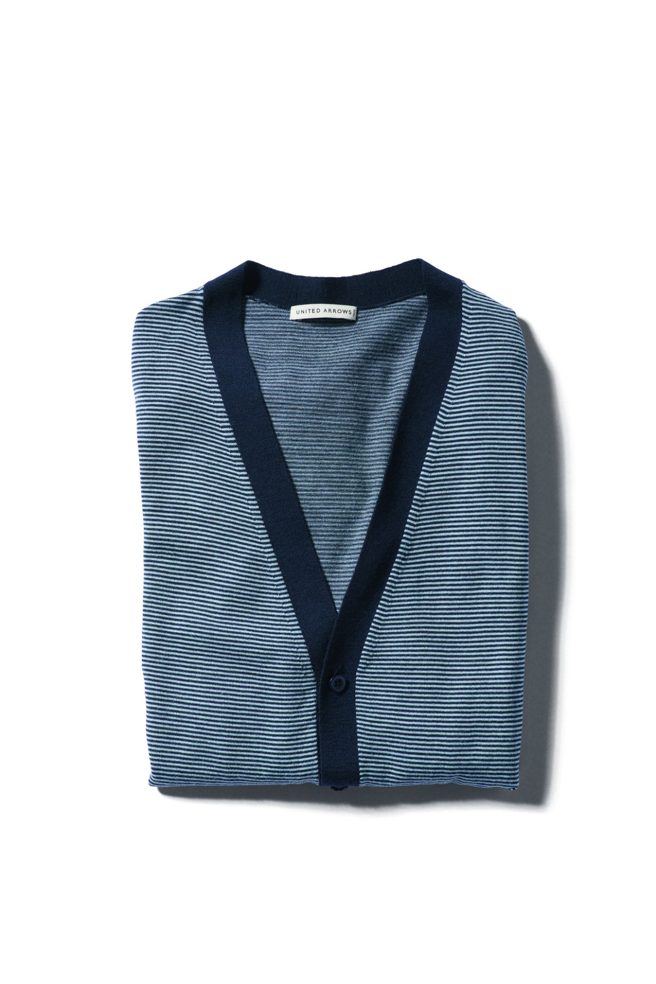 Navy and white striped cardigan by United Arrows photographed against white background