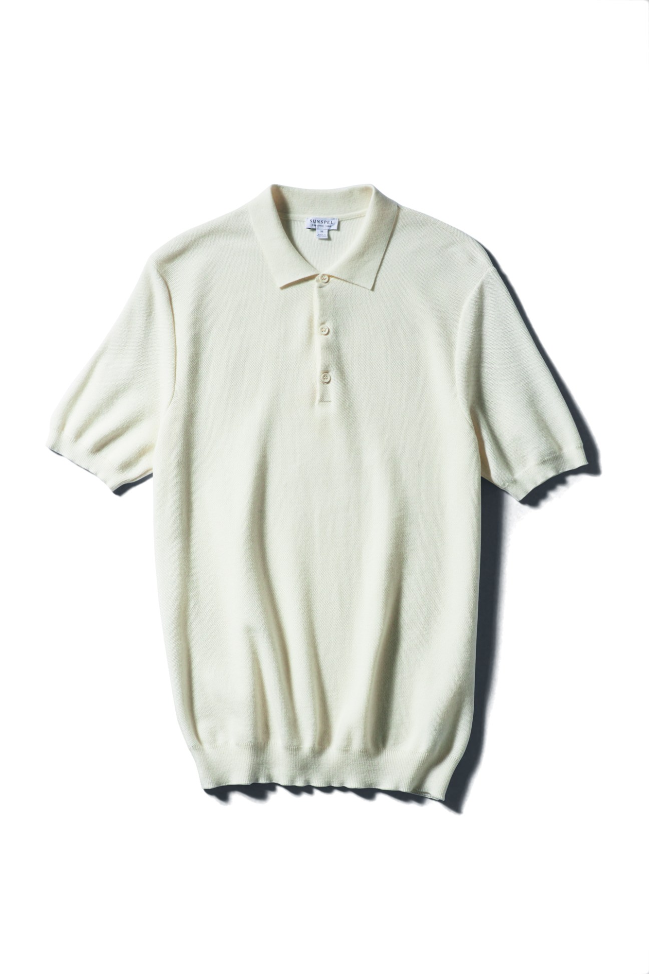 Light sage green knitted polo shirt with collar and three-button placket by Sunspel
