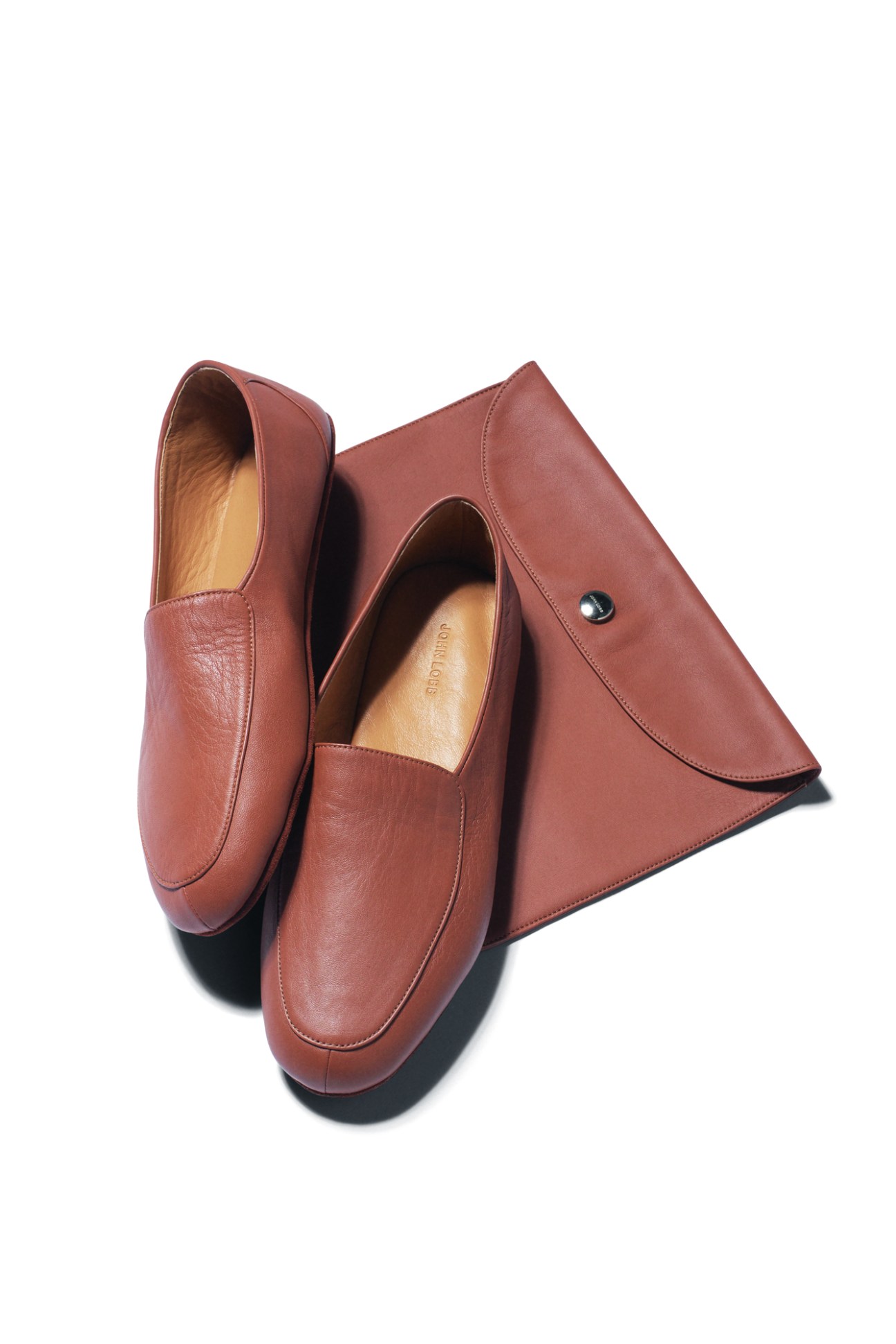 Brown leather loafers and matching envelope clutch bag by John Lobb