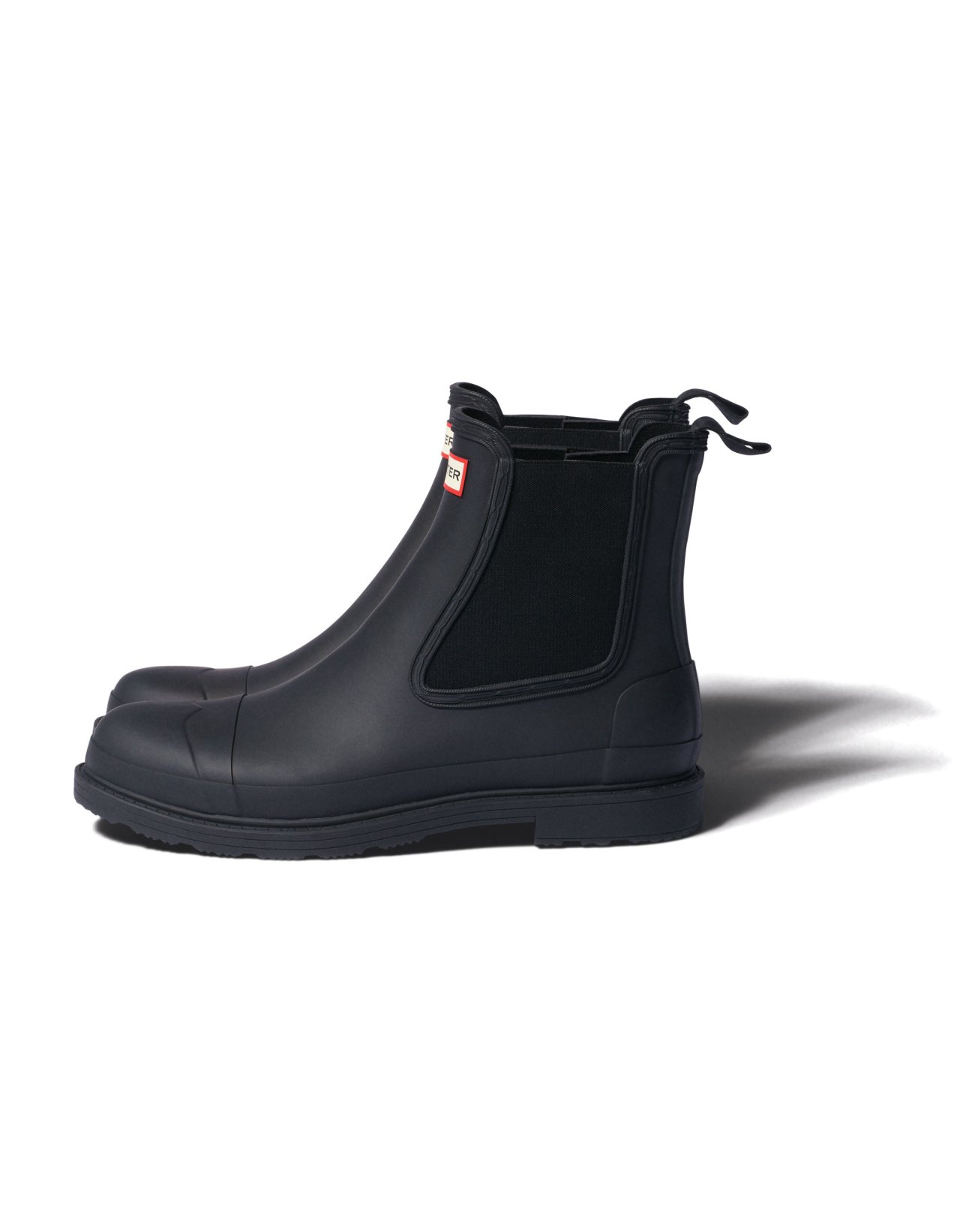 Black rubber Chelsea boots by Hunter with elastic side panels and pull tabs