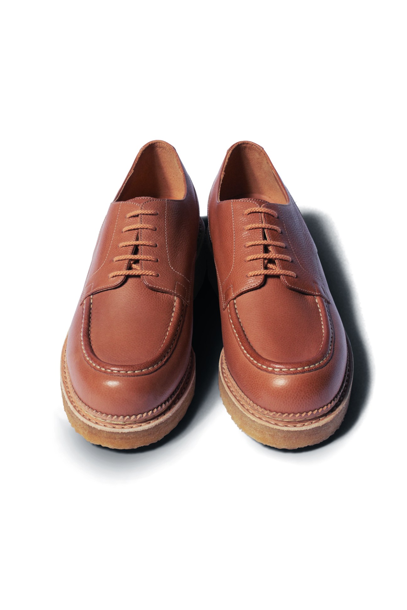 Brown leather lace-up shoes by JM Weston with moccasin-style toe stitching and thick rubber soles