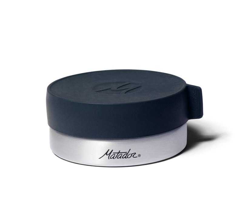 Matador travel canister with dark blue lid and silver base on white background