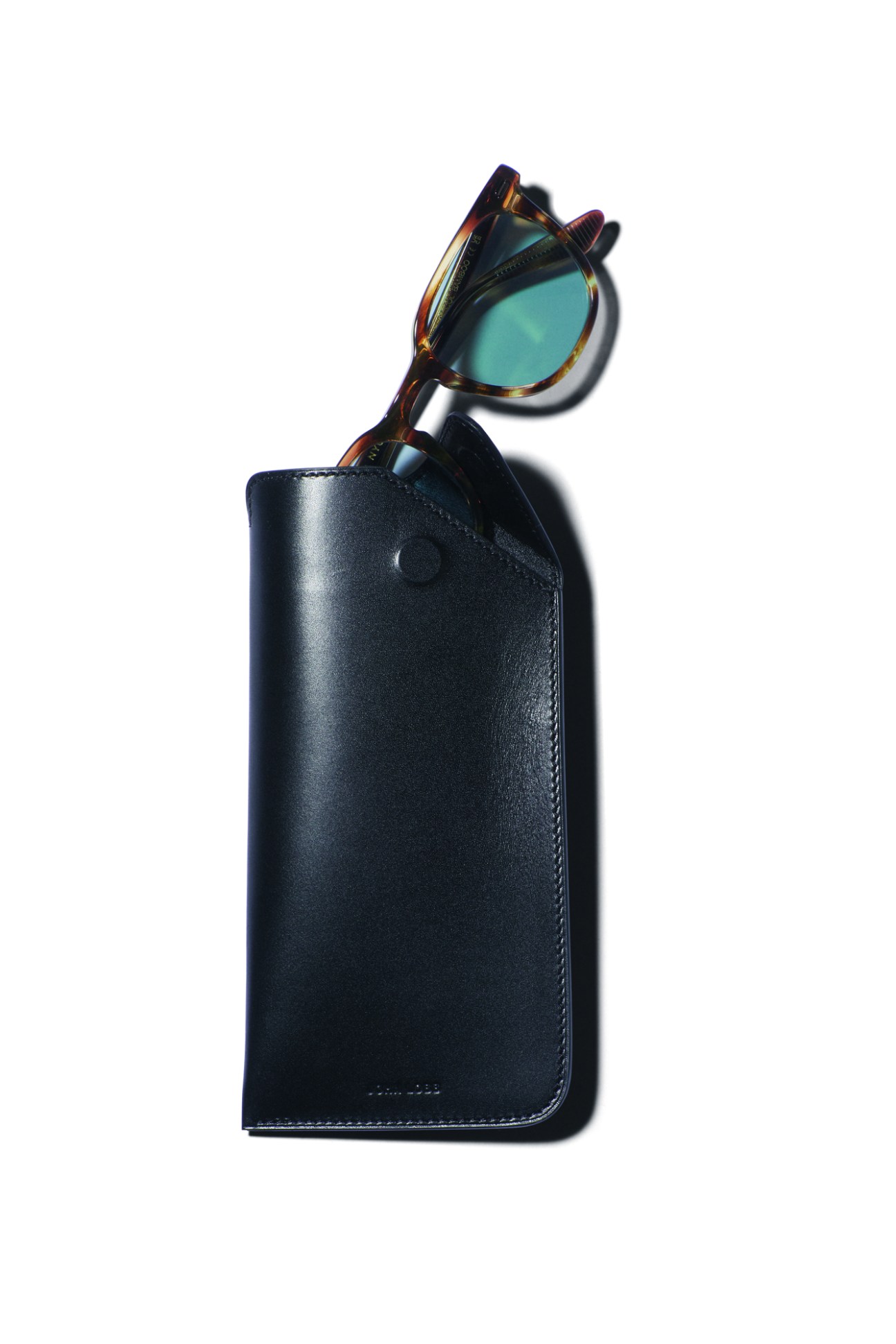 Tortoiseshell sunglasses with blue-tinted lenses emerging from a black leather glasses case