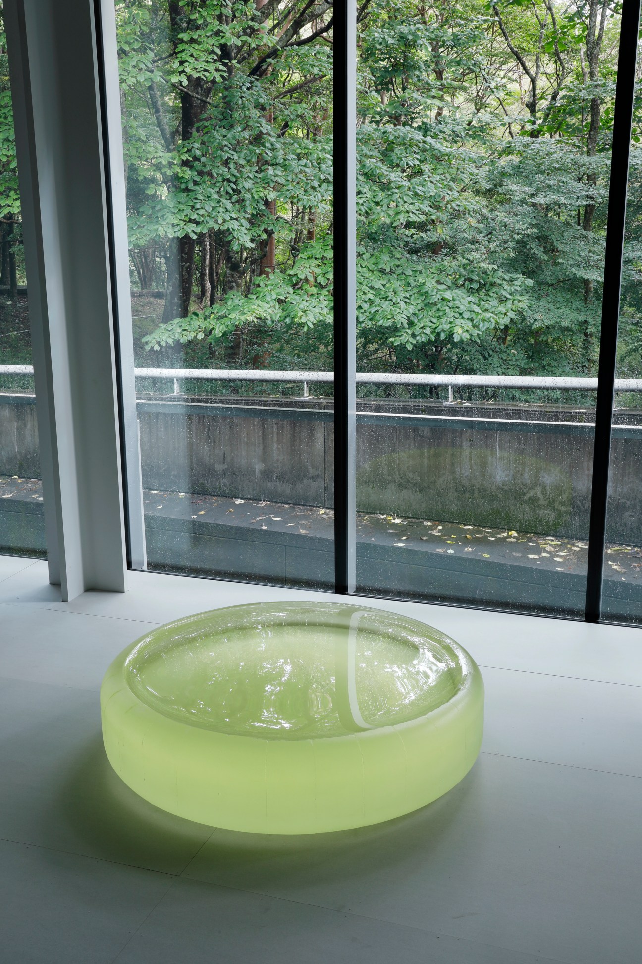Translucent green glass sculpture by Roni Horn displayed in a minimalist gallery space