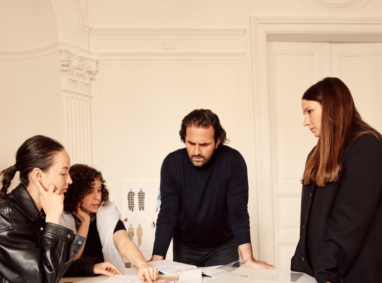 Peter Baldaszti and Sandra Sandor meeting with team members around a table in their Budapest office