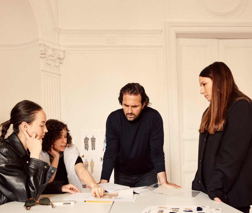 Peter Baldaszti and Sandra Sandor meeting with team members around a table in their Budapest office