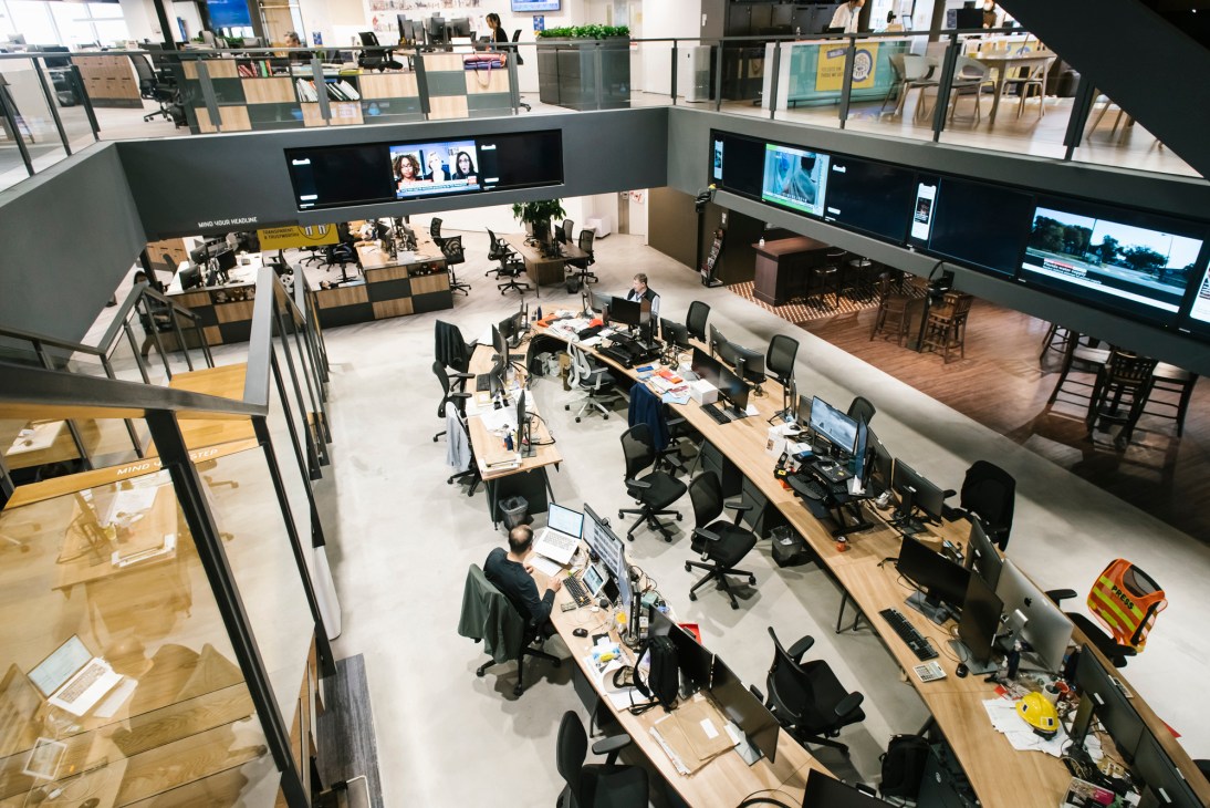 Open plan newsroom showing central desks where senior editors work together