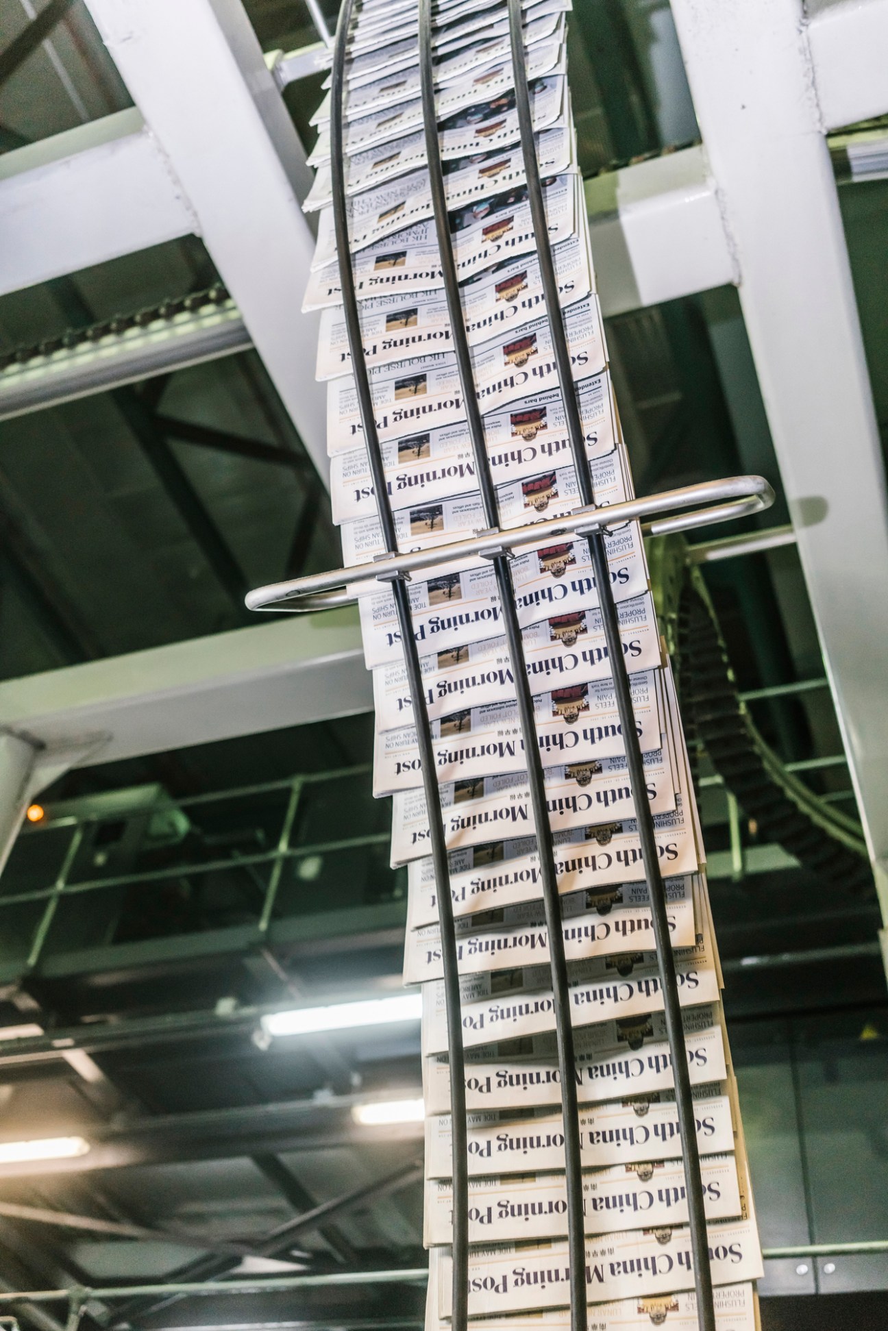 Freshly printed newspapers coming off the printing press at SCMP facility