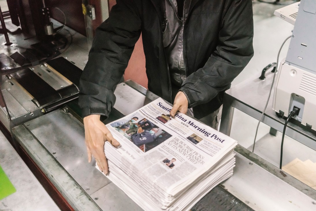 Stacks of freshly printed newspapers bundled and ready for distribution